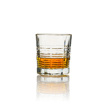 Glass of whisky - without ice and reflection, studio shot. Isolated on white