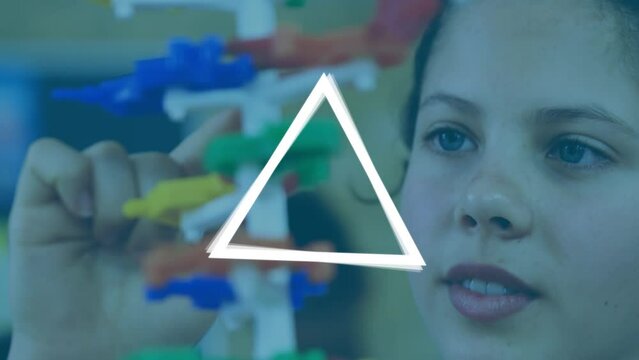 Animation of white triangles over caucasian schoolgirl with model