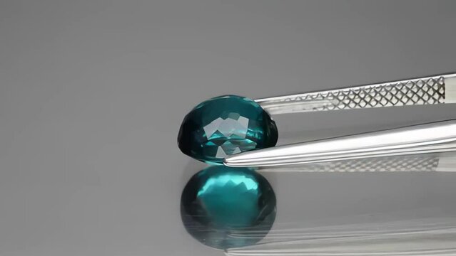 natural dark blue tourmaline indicolite oval cut in the tweezers