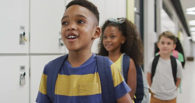 Video Of Happy Diverse Pupils Standing In Row And Smiling Before Entering Classroom