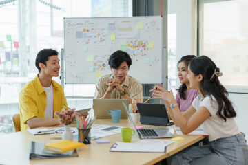 Fototapeta premium Group of young Asian business people meeting in casual wear working together on new project.