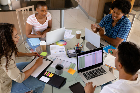 High angle view of biracial business colleagues working together at home office table