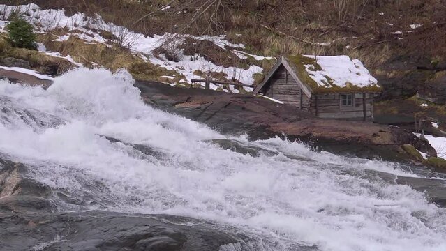 Slow motion water passing water mill in Norway