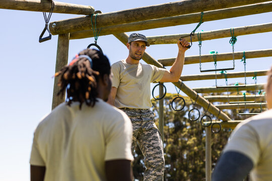Caucasian male soldier instructing other soldiers during obstacle course at boot camp