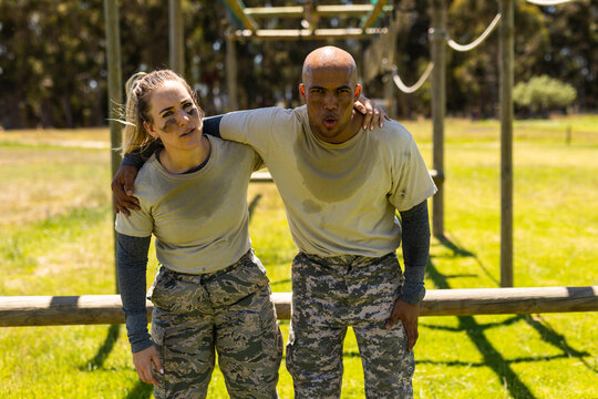Tried male and female soldiers standing together at boot camp