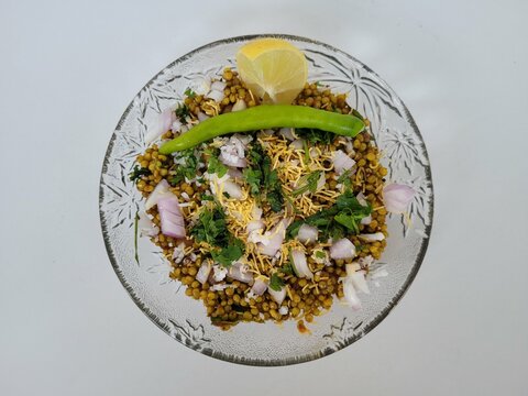 Hurda, Tender Jowar or Sorghum Bhel served in a bowl with green chilly and lemon. Selective focus