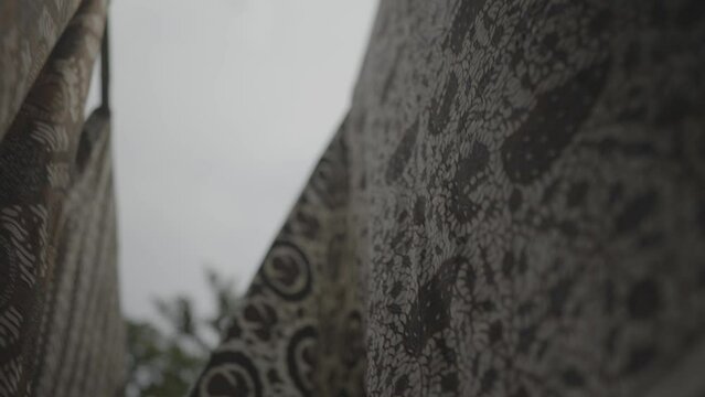 Batik in Java Traditional Fabric of Indonesia - Hanged Cloths Blown by The Wind