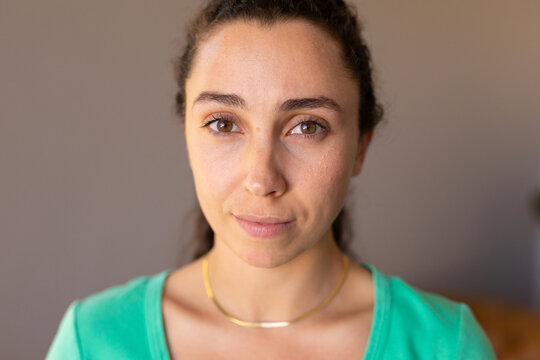 Portrait of beautiful caucasian young woman at home looking at the camera