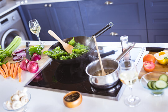 High angle view of cooking pan with fresh vegetables on stove top in kitchen at home