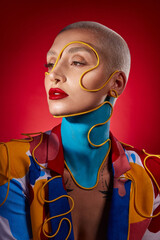 I was never one to color inside the lines. Studio shot of a stylish young woman posing against a red background.