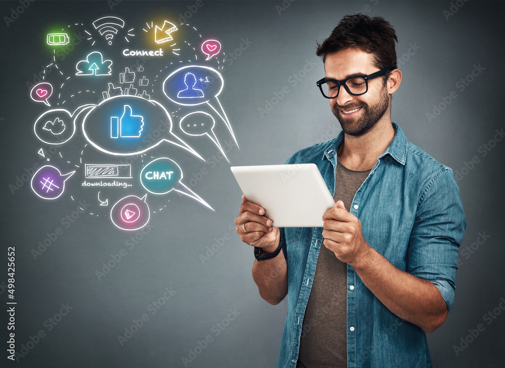 Fototapete theres so many apps to choose from. studio shot of a handsome young man browsing on his tablet while