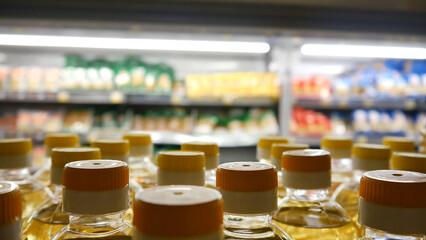 Close-up of many sunflower oil bottles on a store shelf