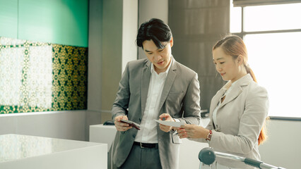Fototapeta premium Young business woman at check-in counter with airlines staff. Airline transportation and tourism concept.