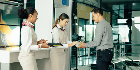 Airplane passenger checking in giving her flight ticket to airline attendant.