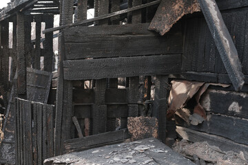 House destroyed by fire. Burnt wooden house.