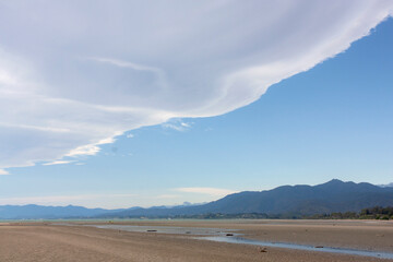 white cloud over the beach at low tide