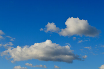 Soft white clouds in a brilliant blue sky
