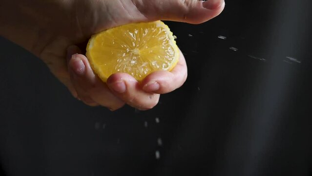 Citrus fruit - squeezing a lemon by hand