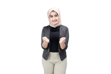Asian Muslim woman in headscarf standing with open palm showing something