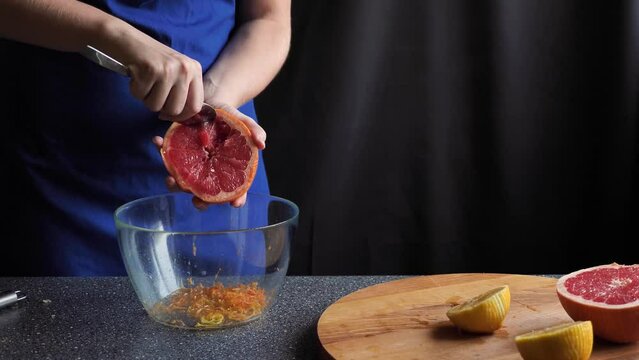 Citrus fruit - squeezing a grapefruit by hand