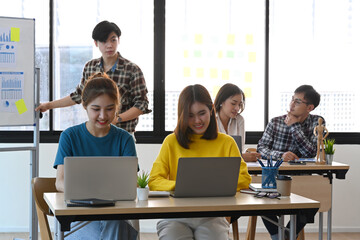 Startup business people working together at bright office with modern devices.