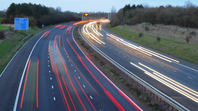 busy traffic at dusk on the M40 motorway.  Time lapse, streaks of light