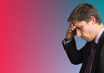 Caucasian businessman holding his head against copy space on blue and pink gradient background