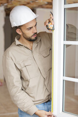 a construction worker installing window