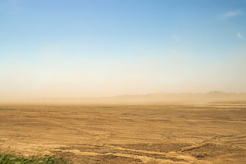 Fototapeta na wymiar Defocused image. Desert sandstorm. Dust and sand in the air.