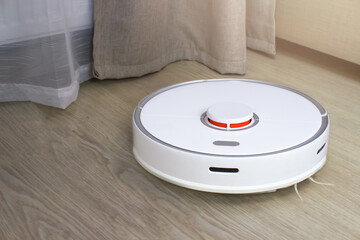 Cleaning the apartment with a robot vacuum cleaner. Automatic floor washing.