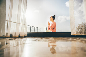 Woman practicing yoga at the backyard. Healthy lifestyle.