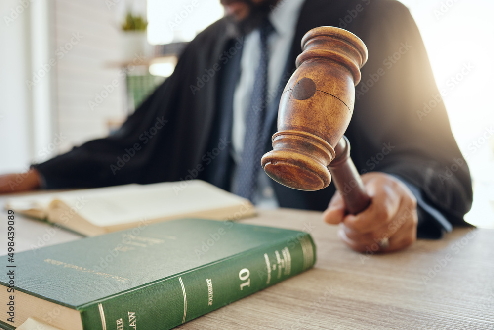 Poster we need order in here. shot of an unrecognizable lawyer using a gavel at work.