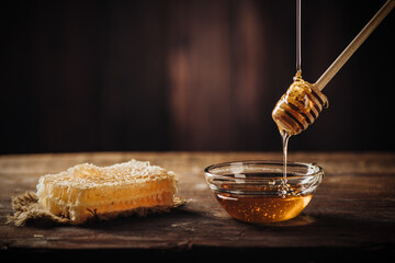 Homemade honey with honeycomb on a rustic wooden table