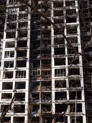 A destroyed multi-storey residential building in the city after a rocket attack. Military attack on...