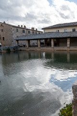 Obraz premium Ancient natural hot springs pool in small Italian village Bagno Vignoni in Tuscany
