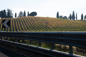 Driving on Italian highway with view on Chianti vineyards on hills in Tuscany, Italy