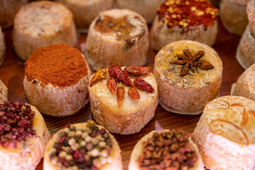 Variety of French soft goat cheese with different toppings, indian, curry, pepper, spicy