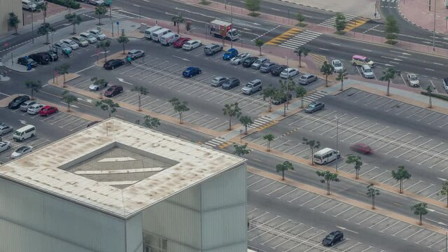 Big parking lot near mall crowded by many cars timelapse aerial view