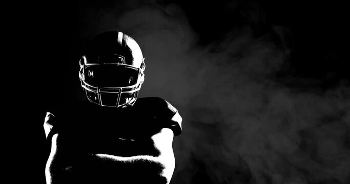 Animation of smoke with male american football player with arms crossed