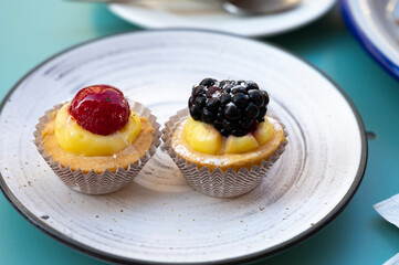 Mini fruit italian cupcakes with fresh berries on board