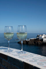 Drinking of white wine with view on blue Atlantic ocean on Tenerife, Canary islands, Spain