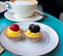 Mini fruit italian cupcakes with fresh berries on board