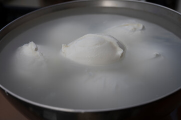 White balls of Italian soft cheese Mozzarella di Bufala Campana on Italian cheese farm, Campania, Italy