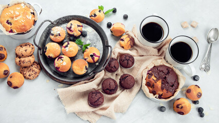Muffins assortment on light background.