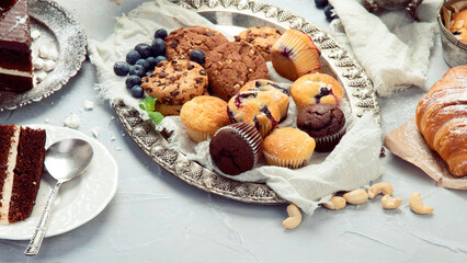Dessert table with all kinds snacks on light background.