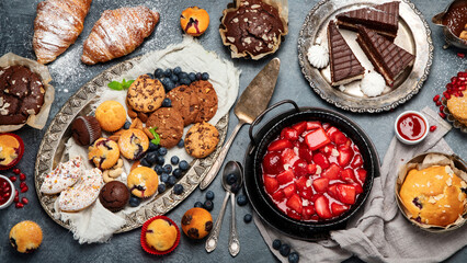 Dessert table with all kinds of cakes and snacks.