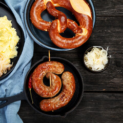 Grilled German sausages on wooden background.