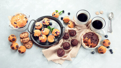 Muffins assortment on light background.