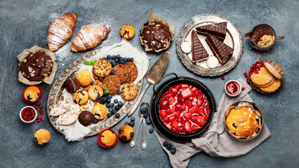 Dessert table with all kinds of cakes and snacks.