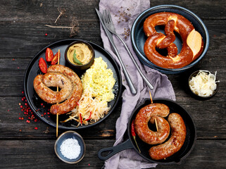 Grilled German sausages on wooden background.